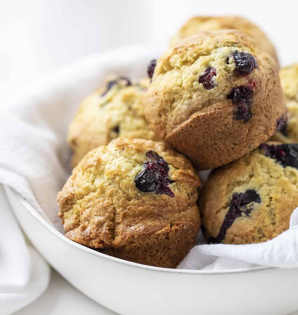 Use your sourdough starter to make these moist and fluffy Sourdough Blueberry Muffins. sourdough blueberry muffins, blueberry muffins, muffins recipes, blueberry recipes, breakfast, iambaker, i am baker, sourdough starter Bowl with a White Towel and Sourdough Blueberry Muffins Inside