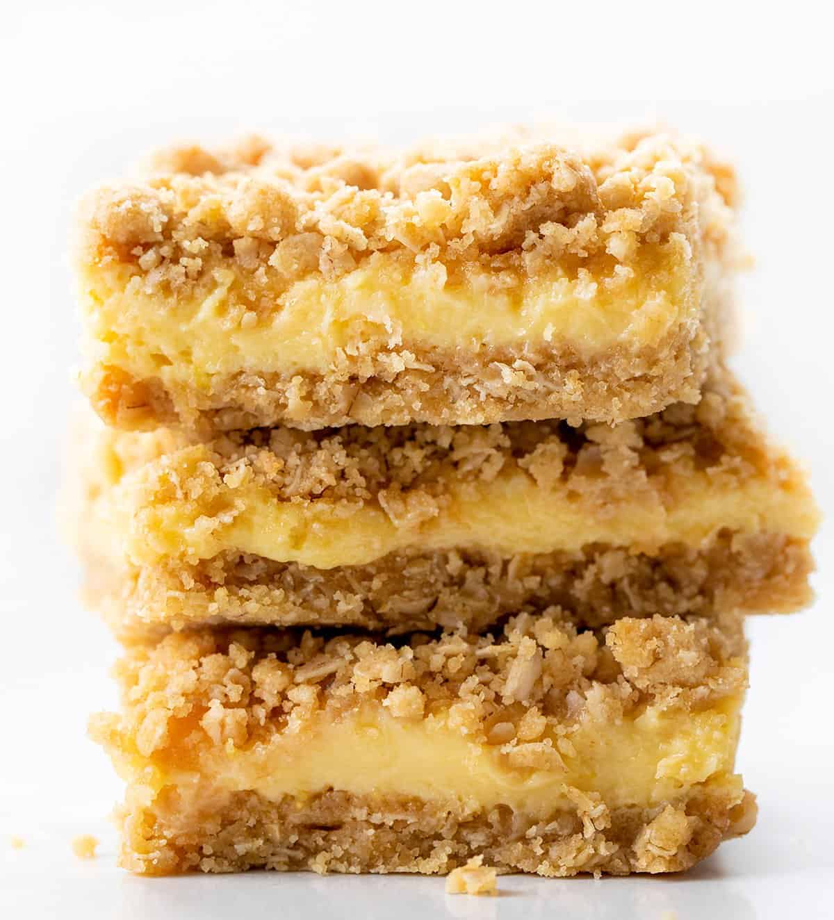 Lemon Crumb Bars are dessert bars filled with lemon filling and flavor in between two layers of an oatmeal crust. They are one of the BEST lemon desserts I have ever had! Lemon Bars, Lemon Crumble, Lemon Crumb Bars, Best Lemon Desserts, Dessert, Summer Dessert, Spring Dessert, Easy Dessert, Crowd Pleasing Dessert, Crumble Dessert, recipes, baking, i am baker, iambaker Stack of Lemon Crumb Bars