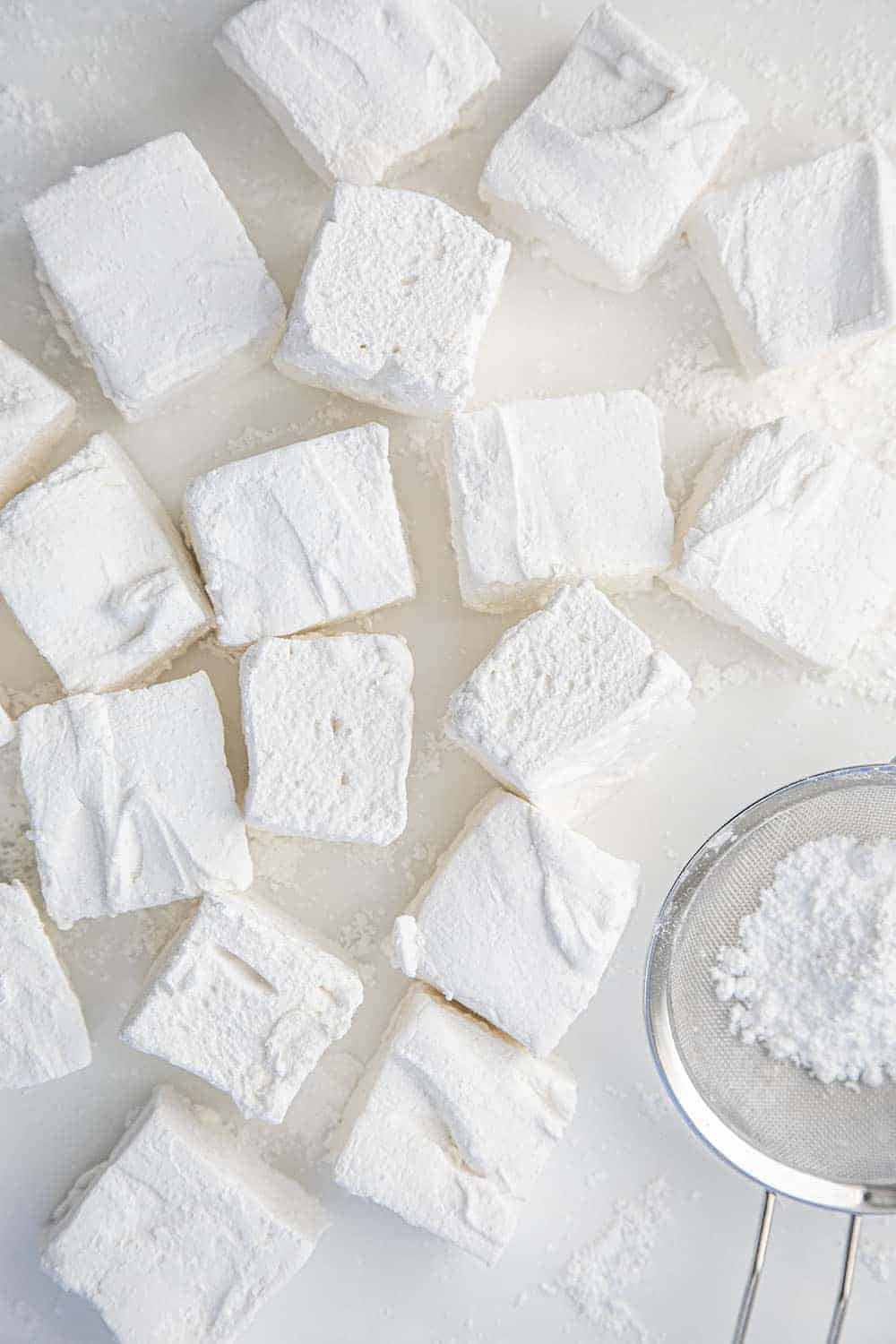 Homemade Marshmallows are better than any you can buy at the store, and they can be made as big or as small, or in any shape, you want! Marshmallows, Homemade Marshmallows, How to Make Marshmallows, Vanilla Marshmallows, i am baker, iambaker, recipes, hot cocoa Scattered Homemade Marshmallows