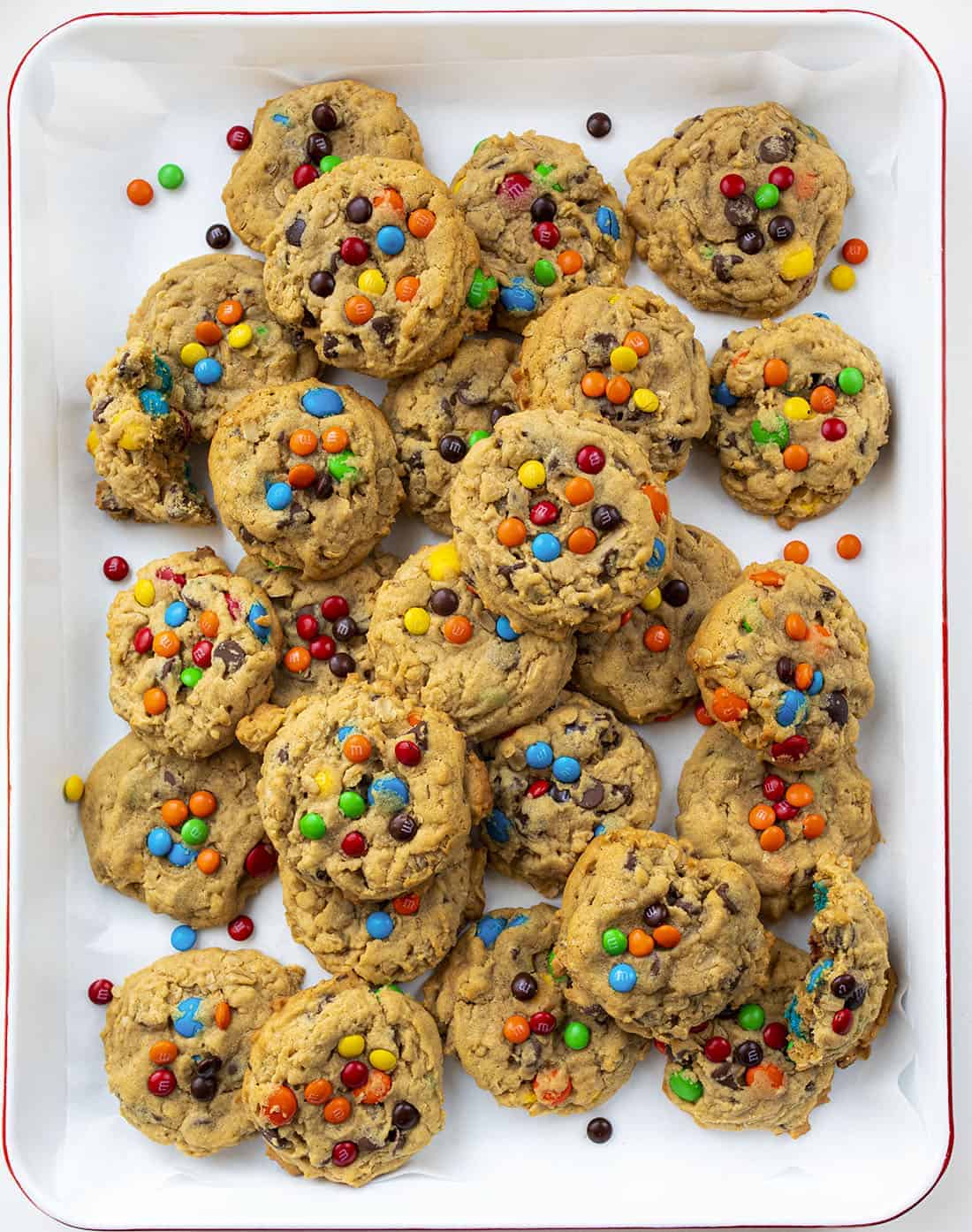 Soft Batch Monster Cookies are a cross between a soft peanut butter cookie and an oatmeal cookie that is loaded with peanut butter, oats, M&M's, and chocolate chips. Cookies, Baking, Monster Cookies, M&M Cookies, Cookie Recipes, i am baker, iambaker, dessert Overhead Tray of Soft Batch Monster Cookies