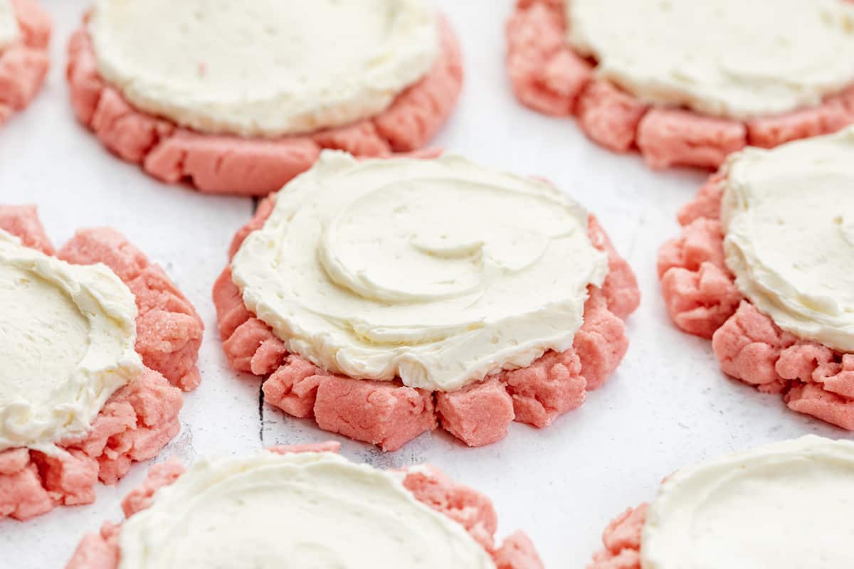 Pink Velvet Sugar Cookies with Vanilla Meringue are soft sugar cookies tinted to a light pink color and frosted with an easy, velvety Swiss Meringue buttercream. Pink Velvet Sugar Cookies with Easy Swiss Meringue.