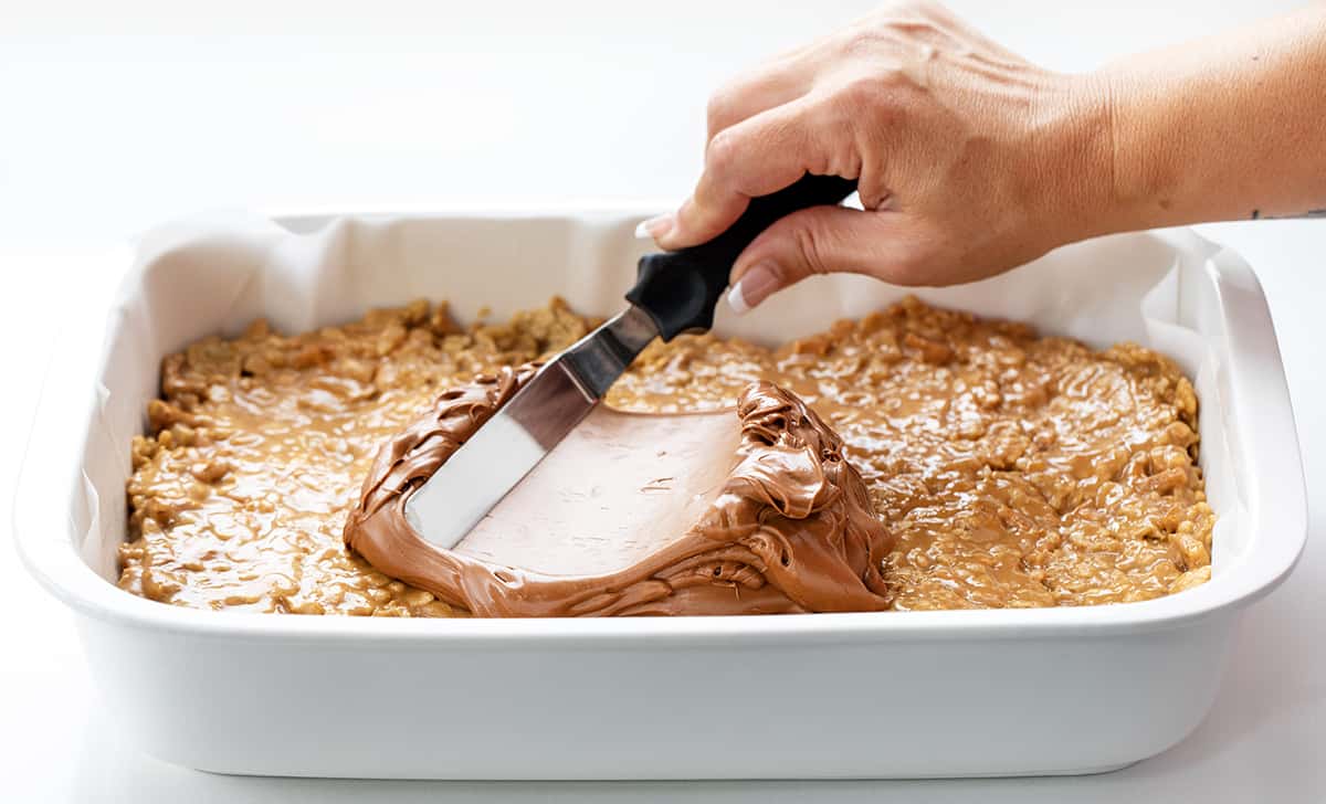 Pretzel Scotcheroos are delightful, no-bake dessert bars that combine sweet, salty, and crunchy flavors and textures. You get the sweetness of the syrup mixture, the richness of peanut butter, the crunchiness of pretzels and cereal, and the smoothness of chocolate and butterscotch. Each bite will surely satisfy both your sweet and salty cravings!