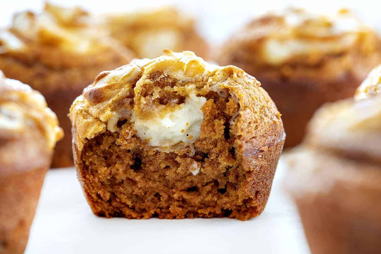 With a cream cheese swirl and a perfectly moist pumpkin muffin, Pumpkin Cream Cheese Swirl Muffins are the best thing about pumpkin spice season! #pumpkincreamcheeseswirlmuffins #muffinrecipes #pumpkinmuffins #iambaker #homemadepumpkinspice #pumpkinspice #baking #desserts #creamcheesefilledmuffins Bit into Pumpkin Cream Cheese Swirl Muffin
