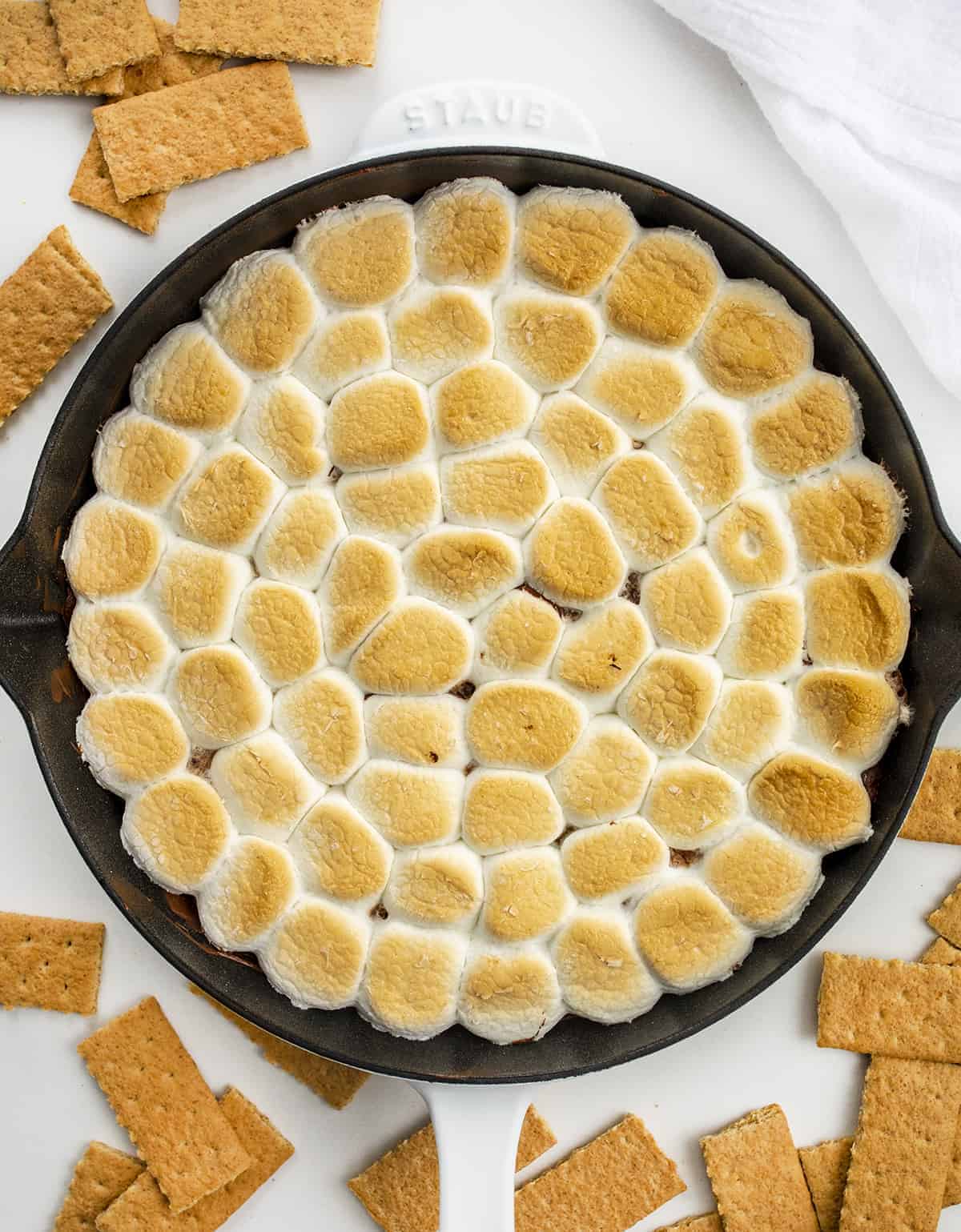 S'mores Dip is a warm, ooey-gooey, chocolatey dip made with melted chocolate chips that are topped with marshmallows and toasted in the oven. Appetizer, Dessert Appetizer, Smores Dip, Smores Dip in the Oven, Dessert, Chocolate, Marshmallow Dip, Skillet Desserts, Skillet Recipes, i am baker, iambaker Skillet of Smores Dip